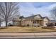 Tan one-story house with a covered porch and landscaped yard at 9748 W Peakview Dr, Littleton, CO 80123