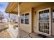 Front porch with white railings and an ornate security door at 9748 W Peakview Dr, Littleton, CO 80123