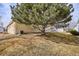 Side view of tan house exterior with landscaping at 9748 W Peakview Dr, Littleton, CO 80123