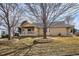 Tan house exterior with covered patio and landscaping at 9748 W Peakview Dr, Littleton, CO 80123