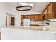 Kitchen features wood cabinets, an island, and skylight at 9748 W Peakview Dr, Littleton, CO 80123