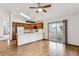 Bright kitchen with wood cabinets, hardwood floors, and breakfast bar at 9748 W Peakview Dr, Littleton, CO 80123