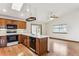 Spacious kitchen with wood cabinets, island, and breakfast bar at 9748 W Peakview Dr, Littleton, CO 80123