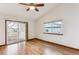 Spacious living room featuring hardwood floors and sliding doors to deck at 9748 W Peakview Dr, Littleton, CO 80123