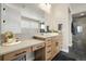 Elegant bathroom featuring double sinks, a vanity area and modern fixtures at 6603 Canyonpoint Rd, Castle Pines, CO 80108