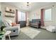 Cozy Bedroom with soft lighting, a comfortable rocking chair, and a charming crib area at 6603 Canyonpoint Rd, Castle Pines, CO 80108