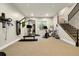 Home gym space with workout equipment, mirrors, and natural light from the egress window at 6603 Canyonpoint Rd, Castle Pines, CO 80108