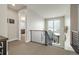 Bright hallway with contemporary railing and plenty of natural light overlooking the exterior at 6603 Canyonpoint Rd, Castle Pines, CO 80108