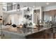 This gorgeous kitchen has an island with granite countertops, pendant lights and stainless steel appliances at 6603 Canyonpoint Rd, Castle Pines, CO 80108