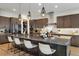 Modern kitchen featuring a large island, stainless steel appliances, and dark wood cabinets at 6603 Canyonpoint Rd, Castle Pines, CO 80108