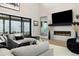 Living room with modern fireplace, large windows, and stylish furniture at 6603 Canyonpoint Rd, Castle Pines, CO 80108