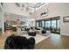 Spacious living room with high ceilings, sleek fireplace, and plenty of natural light at 6603 Canyonpoint Rd, Castle Pines, CO 80108