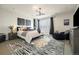 Stylish main bedroom featuring a plush bed, modern decor, and abundant natural light at 6603 Canyonpoint Rd, Castle Pines, CO 80108