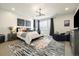 Stylish main bedroom featuring a plush bed, modern decor, and abundant natural light at 6603 Canyonpoint Rd, Castle Pines, CO 80108