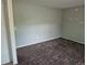 Neutral bedroom featuring gray walls, brown patterned carpet, and natural light at 17900 E Asbury Dr, Aurora, CO 80013