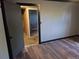 Bedroom features hardwood floors and a glimpse into unfinished space at 17900 E Asbury Dr, Aurora, CO 80013