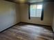 Bedroom with hardwood floors, window, and dark trim for a cozy aesthetic at 17900 E Asbury Dr, Aurora, CO 80013
