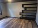 A modern bedroom featuring stylish hardwood floors and unique built-in shelving for storage and decor at 17900 E Asbury Dr, Aurora, CO 80013