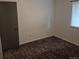 Bedroom featuring a window and closet, with neutral walls and brown patterned carpet at 17900 E Asbury Dr, Aurora, CO 80013
