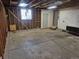 Unfinished two car garage with concrete slab, exposed wood stud framing, and a window at 17900 E Asbury Dr, Aurora, CO 80013