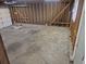 Unfinished two car garage with concrete slab and exposed wood stud framing at 17900 E Asbury Dr, Aurora, CO 80013