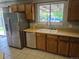 Kitchen with wood cabinets, double sink, and stainless steel appliances offer ample storage at 17900 E Asbury Dr, Aurora, CO 80013