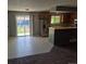 Open kitchen and dining area features tile floors, stainless refrigerator, and sliding glass door at 17900 E Asbury Dr, Aurora, CO 80013