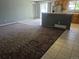 Open-concept living space featuring a kitchen with tile flooring and a living room with carpet at 17900 E Asbury Dr, Aurora, CO 80013