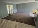 Spacious living room features a large window, carpeted floors, and neutral paint colors at 17900 E Asbury Dr, Aurora, CO 80013