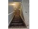 Carpeted staircase featuring a staircase with railings at 17900 E Asbury Dr, Aurora, CO 80013