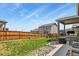 Well-maintained backyard with a lush lawn, rock border, and outdoor seating area at 16099 Alberta Dr, Parker, CO 80134