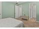 Bedroom with carpet, light green walls, and doorway to the bathroom with glass shower at 16099 Alberta Dr, Parker, CO 80134