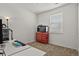 Bedroom featuring desk with gaming PC, red Husky toolbox, and large window with shade at 16099 Alberta Dr, Parker, CO 80134