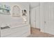 Bedroom featuring changing table on a white dresser, small decor shelves, and doorway at 16099 Alberta Dr, Parker, CO 80134