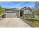 Charming single-Gathering home featuring a two-car garage, stone accents, and manicured landscaping at 16099 Alberta Dr, Parker, CO 80134