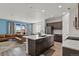 Open-concept kitchen flows to the living area and features a large island, stainless steel appliances, and modern finishes at 16099 Alberta Dr, Parker, CO 80134