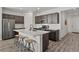 Contemporary kitchen with a large island, dark cabinetry, stainless steel appliances, and a sleek, modern design at 16099 Alberta Dr, Parker, CO 80134