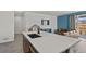 Modern kitchen with a large island, contemporary countertops, and seamless transition into the open living space at 16099 Alberta Dr, Parker, CO 80134