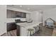 Bright kitchen with a large island, modern cabinetry, stainless steel appliances, and an adjacent playroom at 16099 Alberta Dr, Parker, CO 80134