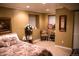 Cozy bedroom featuring carpet, two small windows with white blinds, a floral bedspread and framed wall art at 9926 Apollo Bay Way, Highlands Ranch, CO 80130