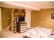 Basement bedroom featuring stairs, carpet, a television with storage and a floral themed bedspread at 9926 Apollo Bay Way, Highlands Ranch, CO 80130