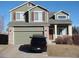 Two-story home with an attached garage, brick accents, neutral siding, and well-kept landscaping at 9926 Apollo Bay Way, Highlands Ranch, CO 80130