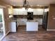 Modern kitchen features white cabinets, granite countertops, stainless steel appliances, and an island at 9926 Apollo Bay Way, Highlands Ranch, CO 80130