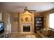 Cozy living room featuring a fireplace, ceiling fan, and a comfortable seating area with natural light at 9926 Apollo Bay Way, Highlands Ranch, CO 80130