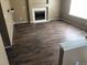Spacious living room with hardwood floors, fireplace, and ample natural light, perfect for entertaining at 9926 Apollo Bay Way, Highlands Ranch, CO 80130