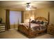 Spacious bedroom with a ceiling fan, large window and a decorative four poster bed at 9926 Apollo Bay Way, Highlands Ranch, CO 80130
