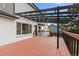 Enjoy outdoor living on this home's wooden deck with pergola and easy access to the living space at 4102 W Union Ave, Denver, CO 80236