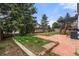 This home features a beautiful backyard with manicured brick patio, garden and pergola-covered deck at 4102 W Union Ave, Denver, CO 80236