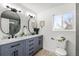 Bathroom with marble countertops, tile floors, and a double vanity at 4102 W Union Ave, Denver, CO 80236