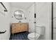 Bathroom with bright blue tile floors, vanity and glass enclosed shower at 4102 W Union Ave, Denver, CO 80236